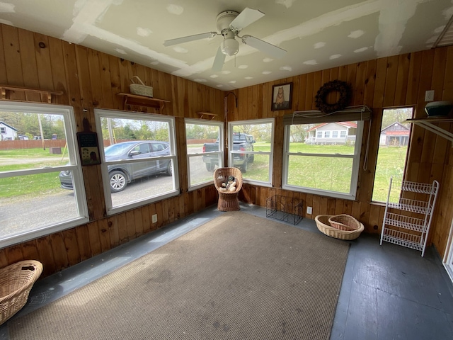 sunroom with healthy amount of natural light and ceiling fan