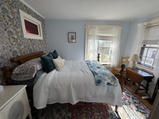 969 Washington St, Bath, ME 04530 - bedroom featuring crown molding, multiple windows, wood finished floors, and wallpapered walls