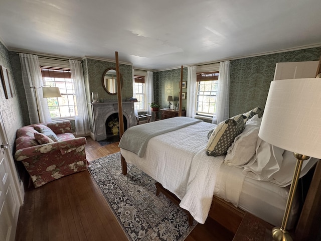 969 Washington St, Bath, ME 04530 - bedroom with wallpapered walls, wood finished floors, and a large fireplace