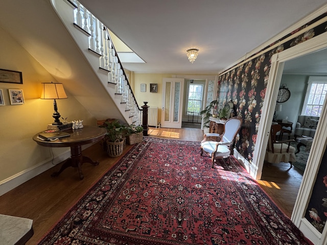 969 Washington St, Bath, ME 04530 - sitting room featuring wood finished floors, baseboards, stairs, and radiator