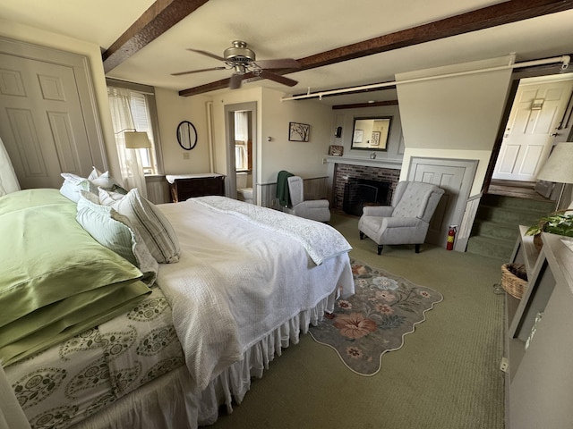 969 Washington St, Bath, ME 04530 - carpeted bedroom with a brick fireplace, beamed ceiling, and ceiling fan