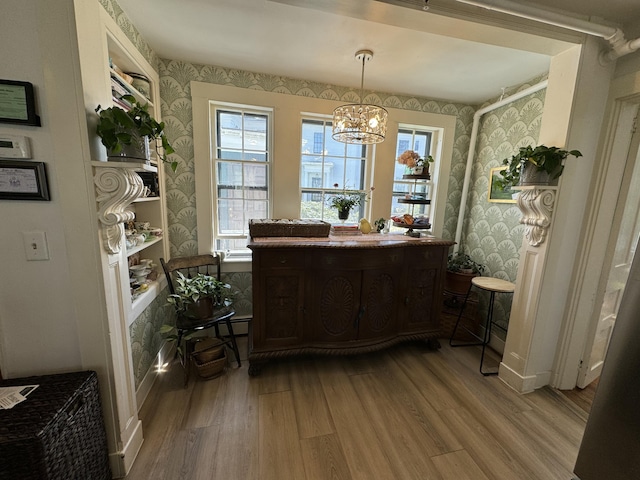 969 Washington St, Bath, ME 04530 - dining room with wallpapered walls, light wood-style floors, a chandelier, and healthy amount of natural light