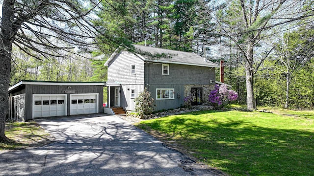 770 Poland Spring Rd, Casco, ME 04015 - view of side of home with asphalt driveway, a garage, and a lawn