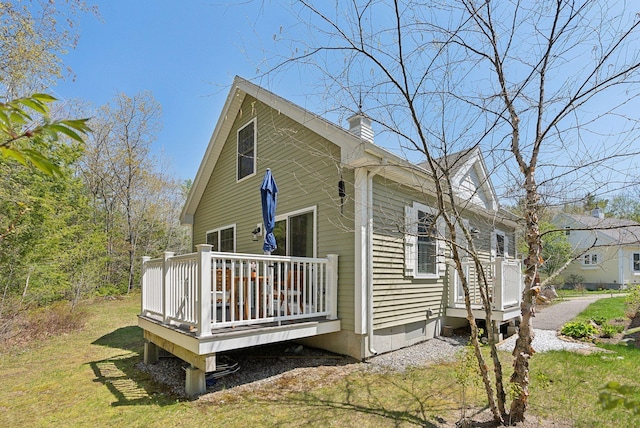 272 Mills Rd Unit 17, Kennebunkport, ME 04046 - view of home's exterior featuring a deck, a chimney, and a yard
