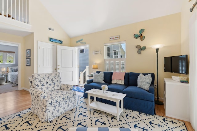 272 Mills Rd Unit 17, Kennebunkport, ME 04046 - living room featuring wood finished floors, baseboards, and high vaulted ceiling