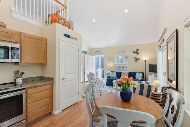 272 Mills Rd Unit 17, Kennebunkport, ME 04046 - dining room featuring light wood-type flooring and high vaulted ceiling
