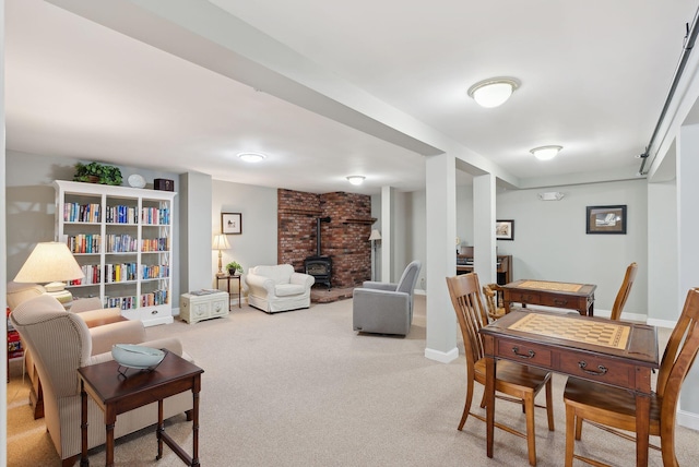 272 Mills Rd Unit 17, Kennebunkport, ME 04046 - dining room featuring a wood stove, carpet, and baseboards