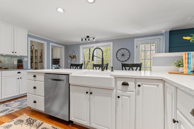 70 Summer St, Kennebunk, ME 04043 - kitchen with stainless steel dishwasher, a sink, healthy amount of natural light, light wood-style floors, and crown molding