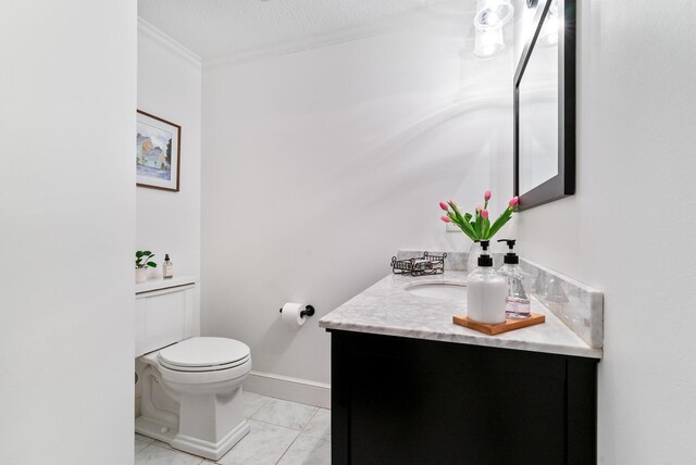 70 Summer St, Kennebunk, ME 04043 - half bathroom featuring toilet, ornamental molding, vanity, marble look tiles, and a textured ceiling