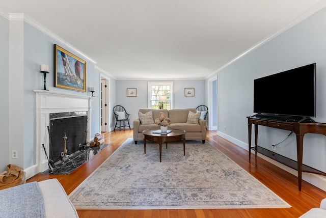 70 Summer St, Kennebunk, ME 04043 - living area with wood finished floors, ornamental molding, baseboards, and a high end fireplace