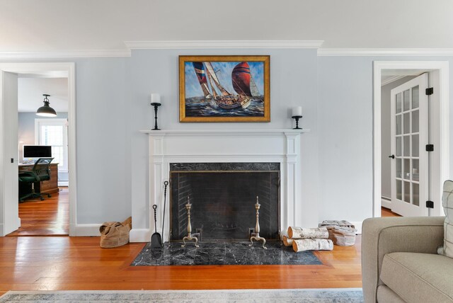 70 Summer St, Kennebunk, ME 04043 - living room featuring wood finished floors, a fireplace, baseboards, and ornamental molding