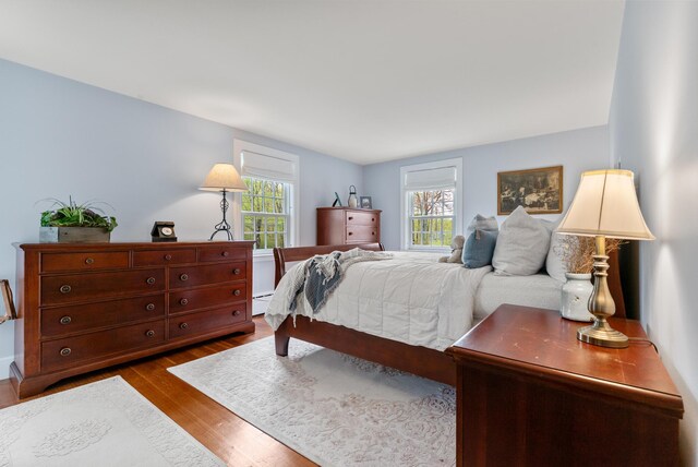 70 Summer St, Kennebunk, ME 04043 - bedroom featuring dark wood finished floors and a baseboard heating unit