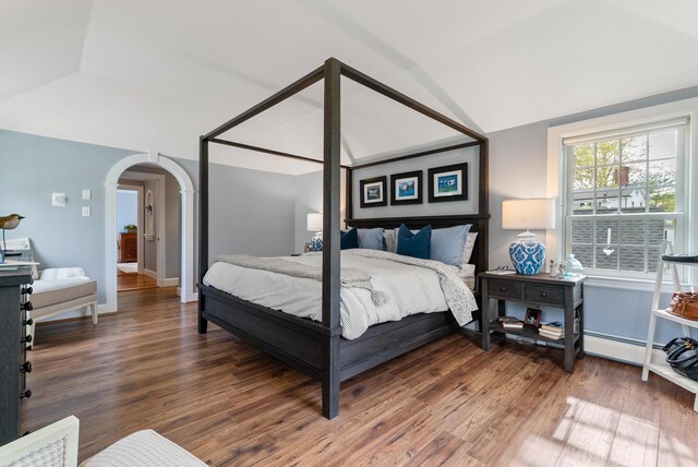 70 Summer St, Kennebunk, ME 04043 - bedroom featuring vaulted ceiling, wood finished floors, arched walkways, and baseboards