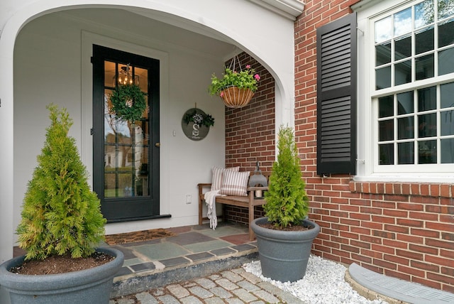 70 Summer St, Kennebunk, ME 04043 - view of exterior entry featuring brick siding and a porch