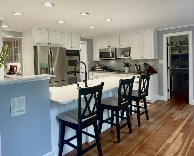 70 Summer St, Kennebunk, ME 04043 - kitchen featuring stainless steel appliances, white cabinetry, a sink, decorative backsplash, and recessed lighting