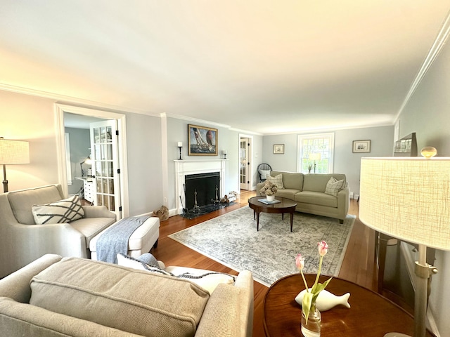 70 Summer St, Kennebunk, ME 04043 - living area featuring wood finished floors, ornamental molding, a fireplace with flush hearth, and baseboards
