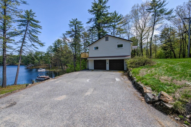 347 Brownfield Rd, Porter, ME 04068 - view of home's exterior featuring a garage, a water view, and driveway