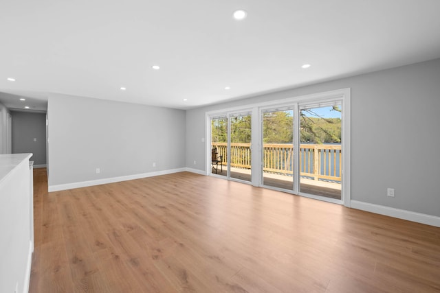 347 Brownfield Rd, Porter, ME 04068 - unfurnished living room with recessed lighting, light wood-style floors, and baseboards