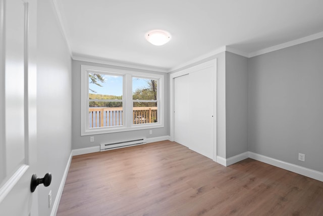 347 Brownfield Rd, Porter, ME 04068 - spare room with a baseboard heating unit, wood finished floors, baseboards, and crown molding