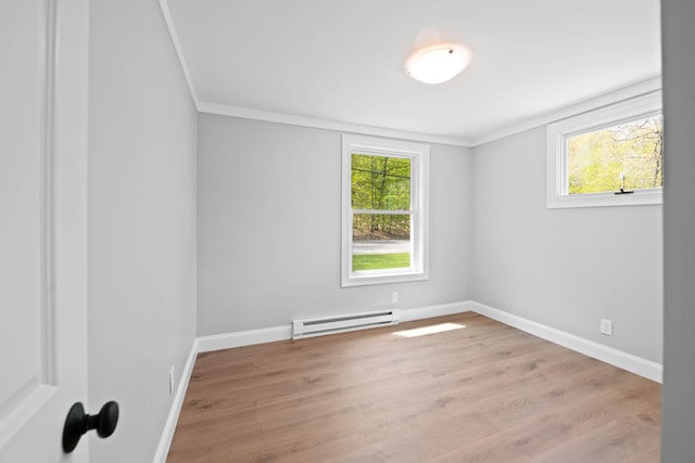 347 Brownfield Rd, Porter, ME 04068 - spare room featuring a baseboard radiator, crown molding, healthy amount of natural light, light wood-type flooring, and baseboards