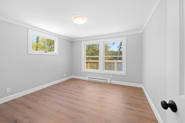 347 Brownfield Rd, Porter, ME 04068 - spare room featuring a baseboard radiator, crown molding, light wood-style floors, and baseboards