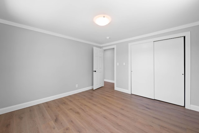 347 Brownfield Rd, Porter, ME 04068 - unfurnished bedroom with ornamental molding, baseboards, light wood-type flooring, and a closet