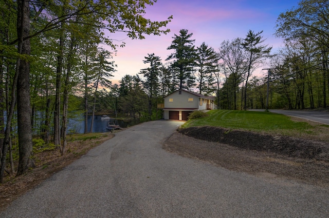 347 Brownfield Rd, Porter, ME 04068 - view of front of home with a garage, driveway, and a water view