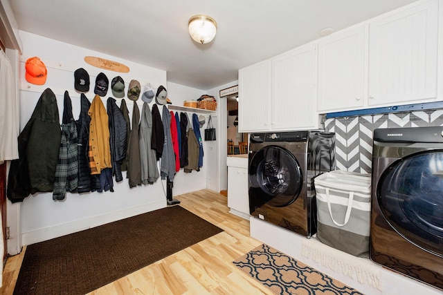 22 Pleasant St, Phillips, ME 04966 - laundry area with cabinet space, washer and clothes dryer, and light wood-type flooring