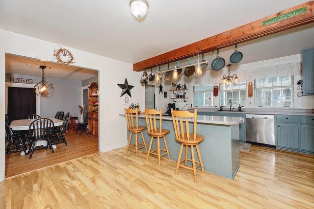 22 Pleasant St, Phillips, ME 04966 - kitchen featuring stainless steel dishwasher, light wood-style flooring, a kitchen bar, healthy amount of natural light, and beamed ceiling