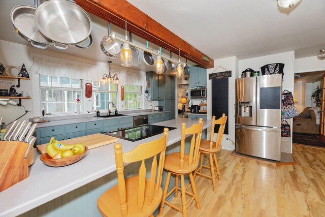 22 Pleasant St, Phillips, ME 04966 - kitchen featuring appliances with stainless steel finishes, blue cabinetry, a sink, light wood-style flooring, and beam ceiling