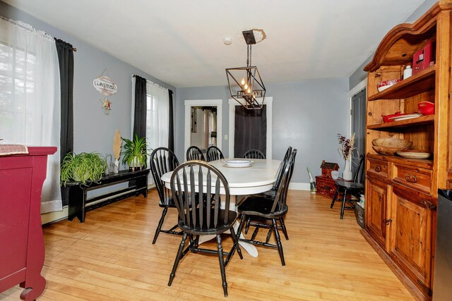 22 Pleasant St, Phillips, ME 04966 - dining area featuring light wood-style flooring and a chandelier
