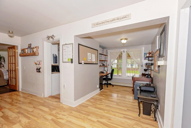 22 Pleasant St, Phillips, ME 04966 - corridor with wood finished floors, a desk, and baseboards