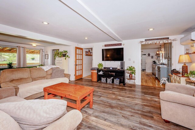 22 Pleasant St, Phillips, ME 04966 - living room featuring a wall mounted AC, wood finished floors, beamed ceiling, and recessed lighting