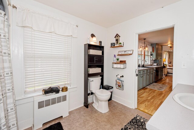 22 Pleasant St, Phillips, ME 04966 - bathroom with radiator heating unit, vanity, and toilet