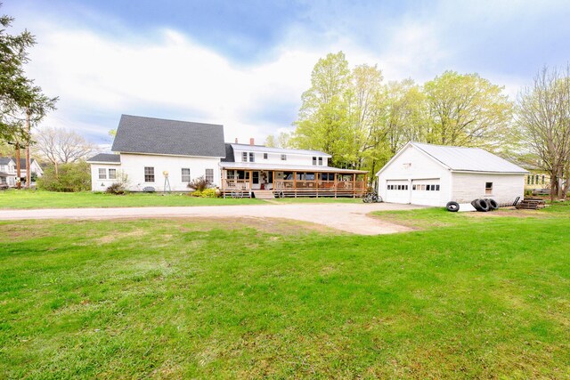 22 Pleasant St, Phillips, ME 04966 - back of property featuring an outbuilding, a garage, a yard, and a wooden deck
