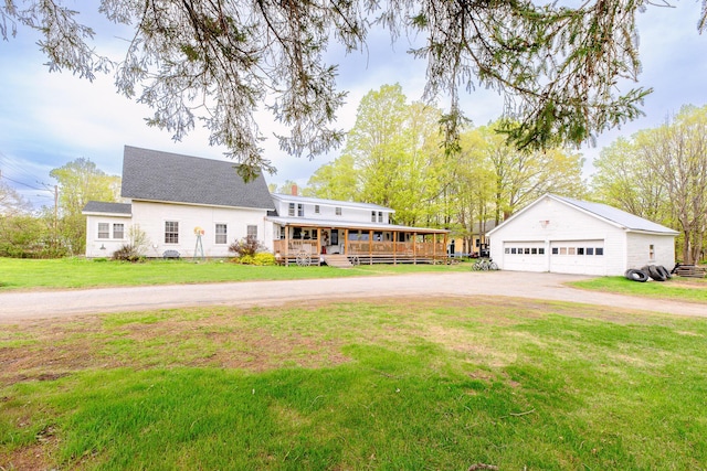22 Pleasant St, Phillips, ME 04966 - view of front facade featuring a detached garage, an outdoor structure, a front yard, and a porch