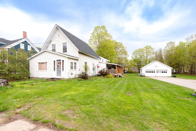 22 Pleasant St, Phillips, ME 04966 - view of property exterior with a detached garage, a yard, and an outdoor structure