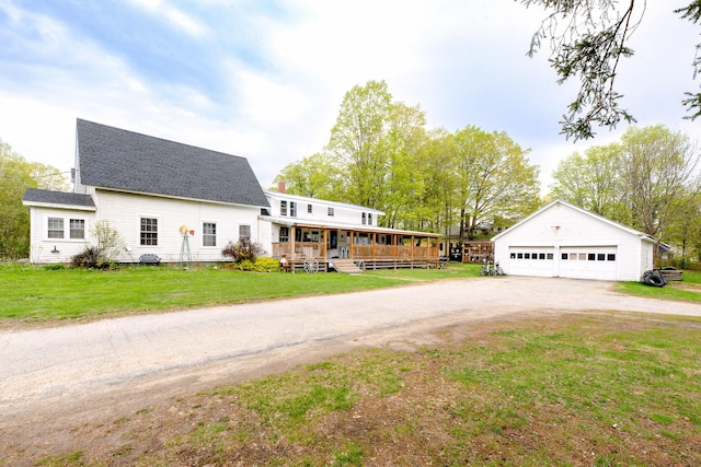 22 Pleasant St, Phillips, ME 04966 - view of front facade featuring a porch, a garage, an outbuilding, a front yard, and roof with shingles