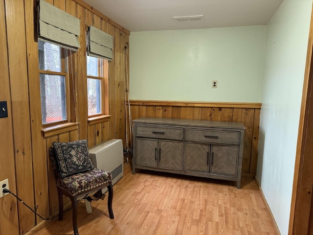 102 Hills Pt, Union, ME 04862 - sitting room featuring wood walls, light wood-style flooring, and wainscoting