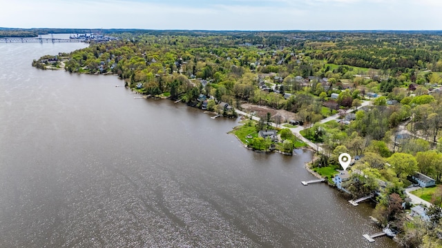 bird's eye view of a nearby body of water and a heavily wooded area