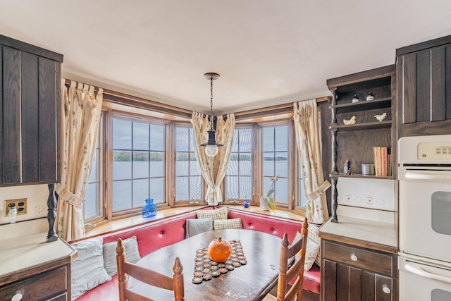 dining area with plenty of natural light and a water view