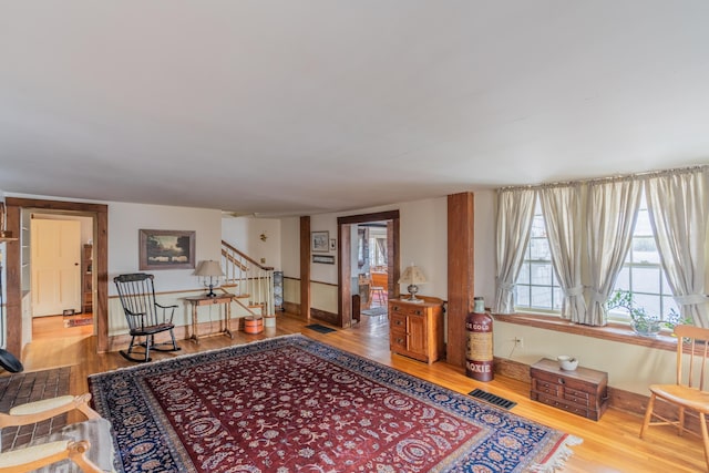 foyer featuring stairway, wood finished floors, and baseboards