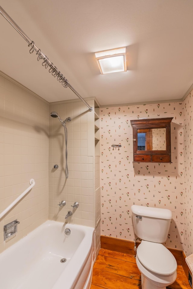 full bath featuring wood finished floors, toilet, shower / tub combination, and wallpapered walls
