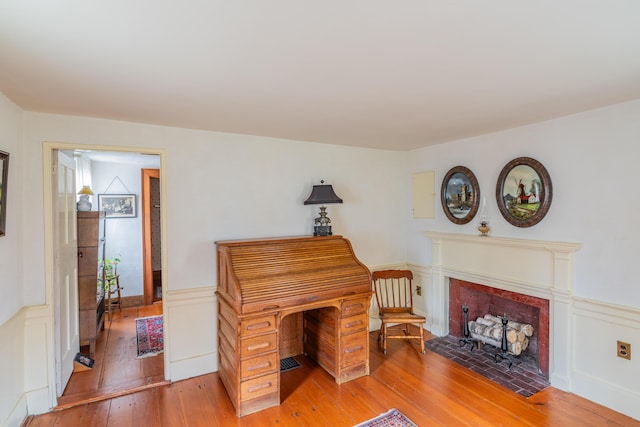 office space featuring hardwood / wood-style flooring and a wainscoted wall