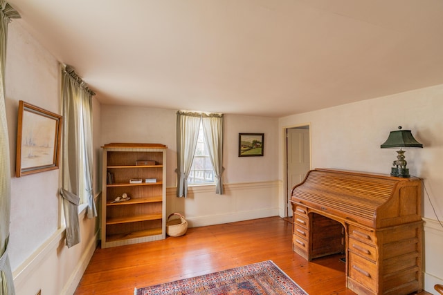 office area featuring wood-type flooring and baseboards