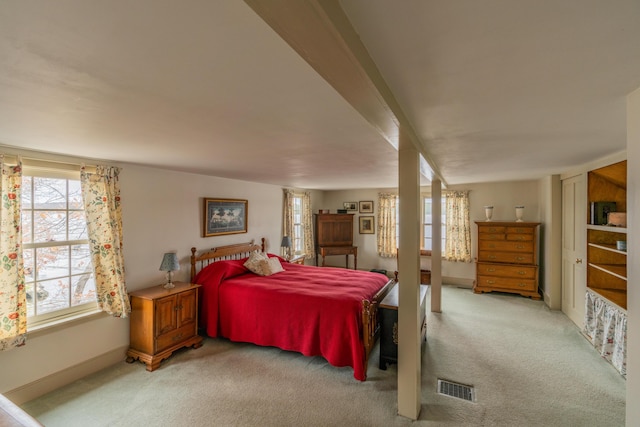 bedroom featuring light carpet and baseboards