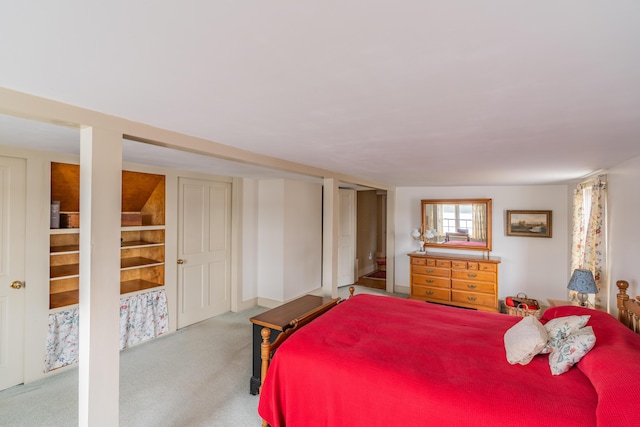 carpeted bedroom featuring multiple closets