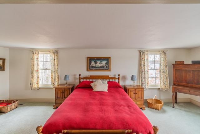 bedroom featuring carpet and baseboards
