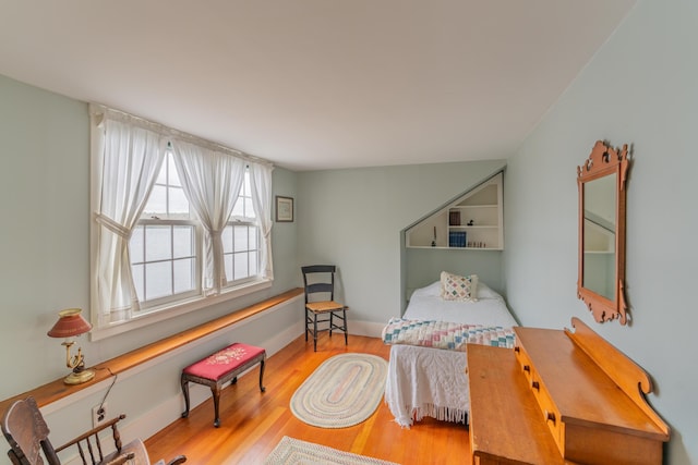 bedroom with wood finished floors and baseboards