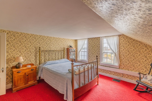 carpeted bedroom featuring wallpapered walls and baseboards